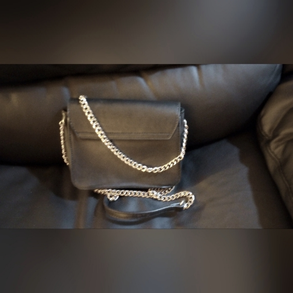 Small black purse with silver chain strap